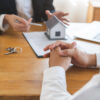Real estate, banker present house model with client before tenant sign contract rental purchase buyer home with landlord, realtor after agreement mortgage success done. Property lease agent concept.