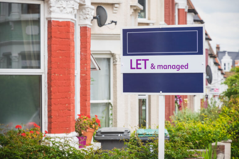 Estate agent sign displayed outside a terraced house in Harringay, London to let rent buy-to-let rental