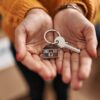 Young woman holding key of new house at new home